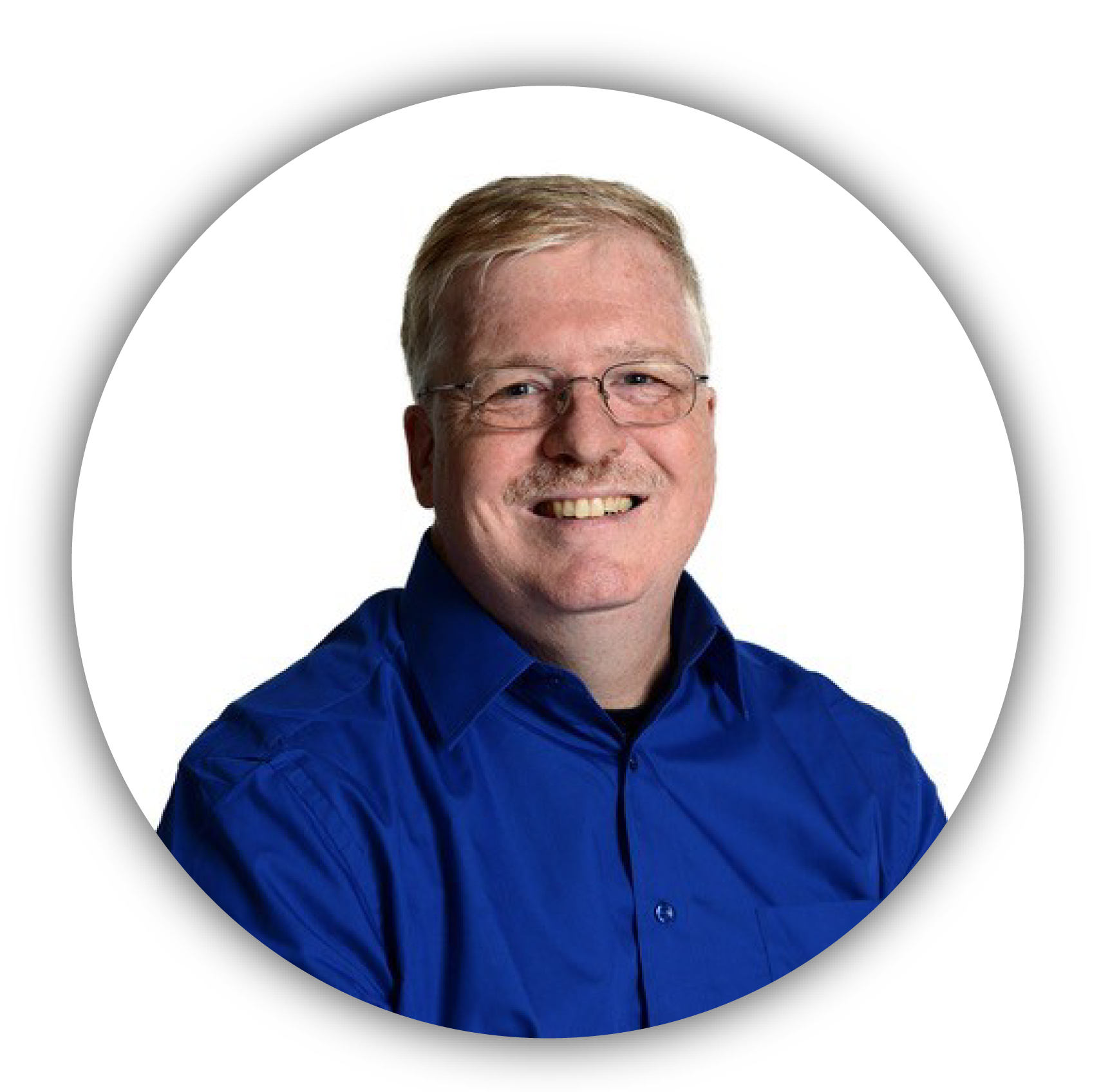 Man with bright blue shirt, glasses and short grey hair smiles