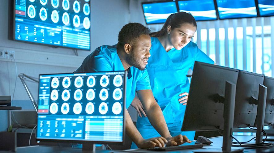 Two researchers looking at a computer in the lab.