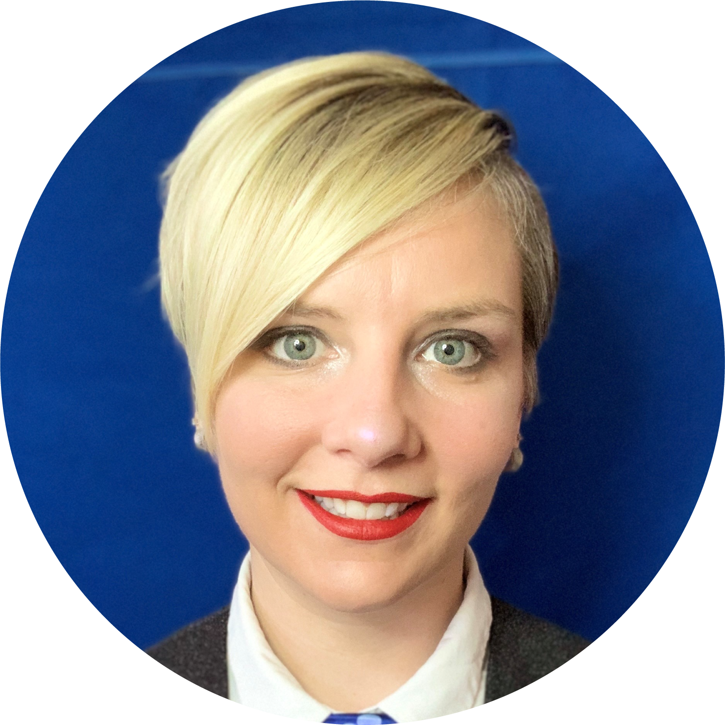 Woman with short blonde hair wearing white buttoned shirt and dark jacket