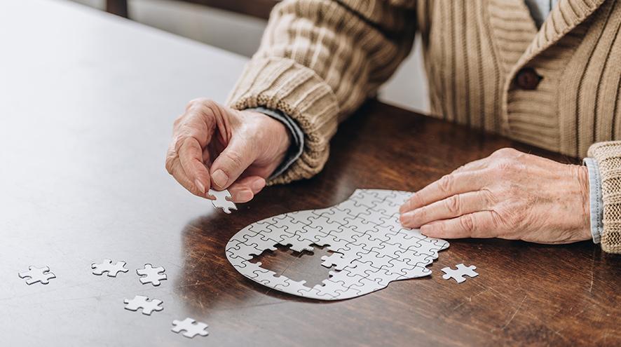 Senior man playing with a puzzle.