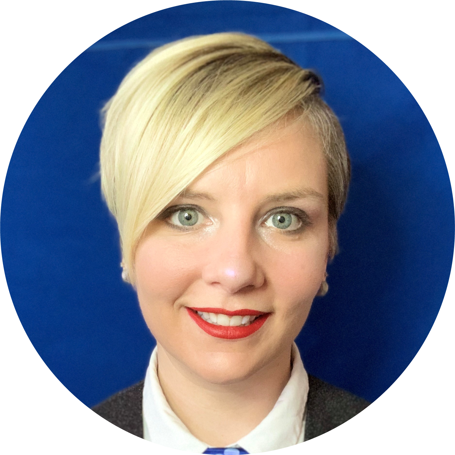 Woman with short blonde hair wearing white buttoned shirt and dark jacket