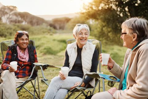 three woman sitting outside having a conversation