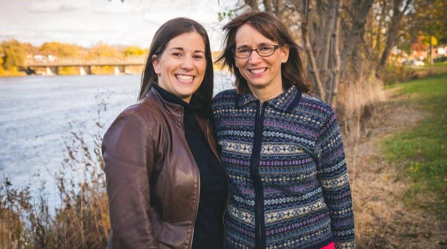 Cassandra and her mother, Karen, standing outside and smiling.