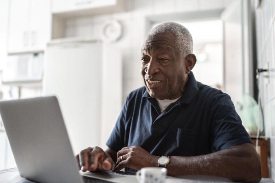 Older man working on a laptop computer