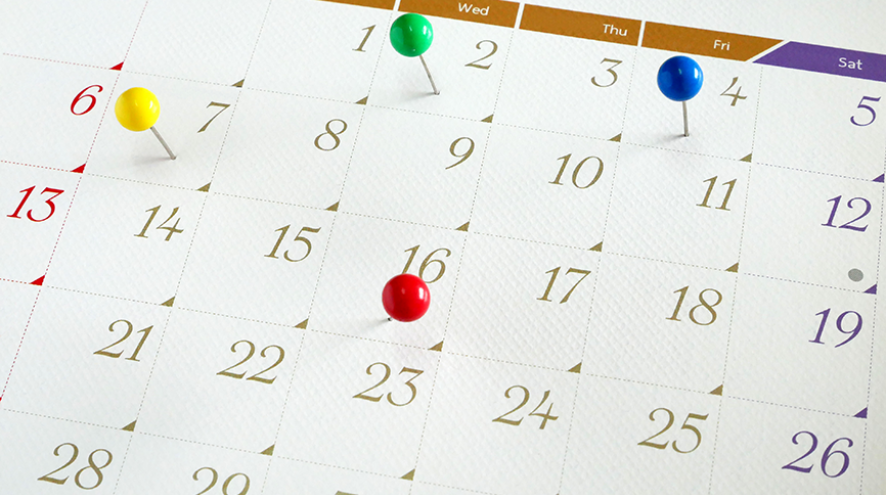 Calendar with coloured pins.