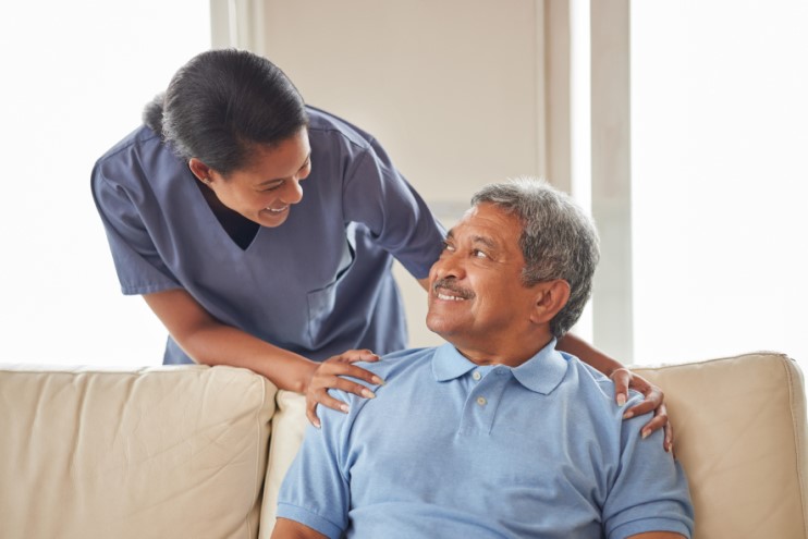 Man and woman smiling sitting on sofa