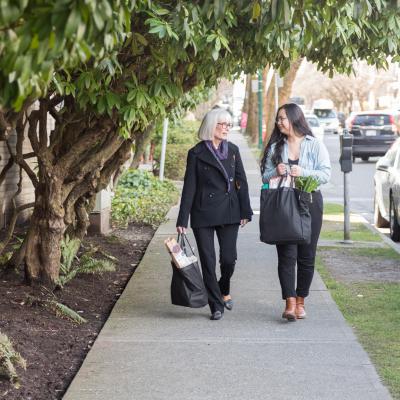 Two woman walking with groceries