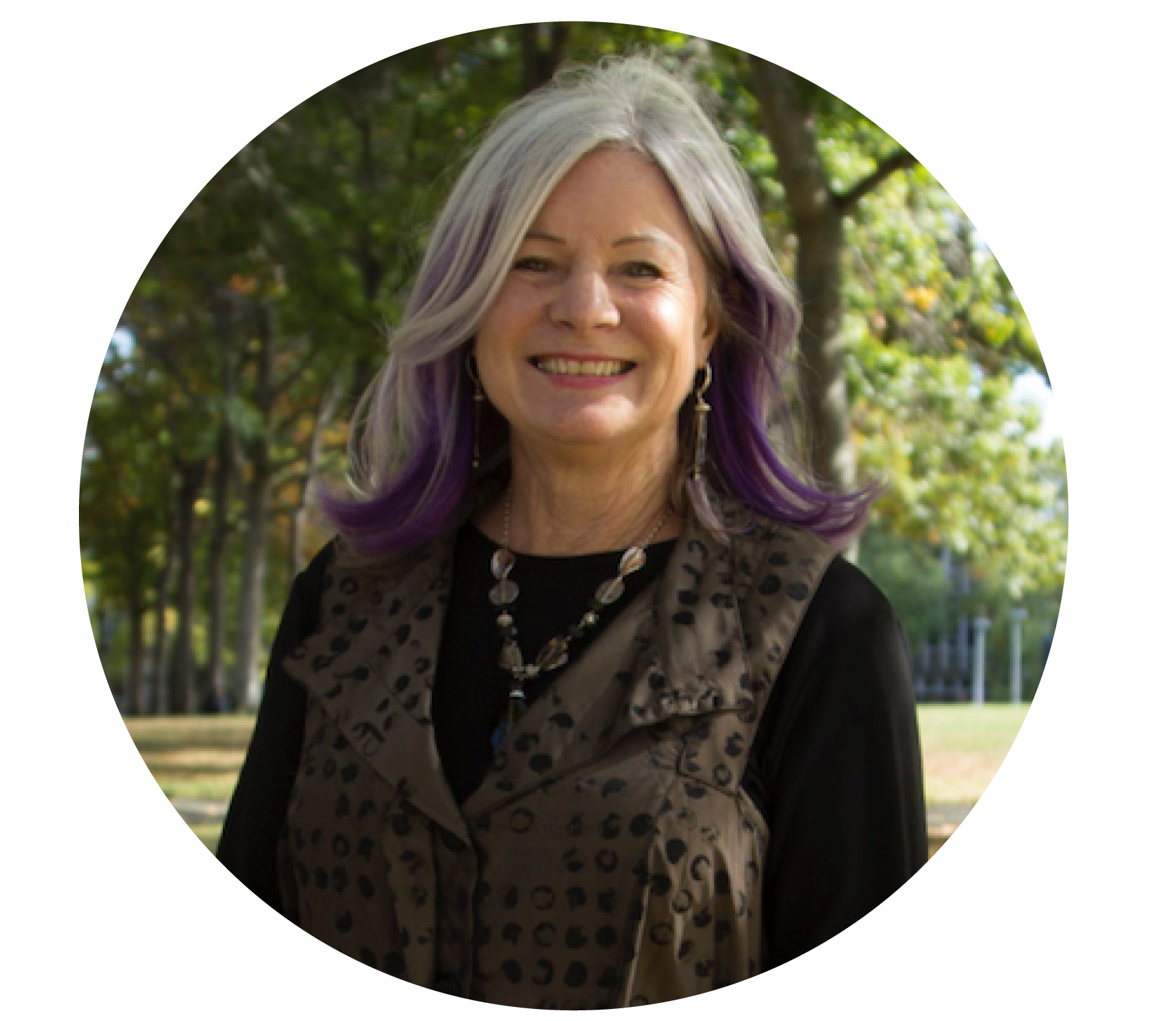 Woman with grey and purple hair smiling