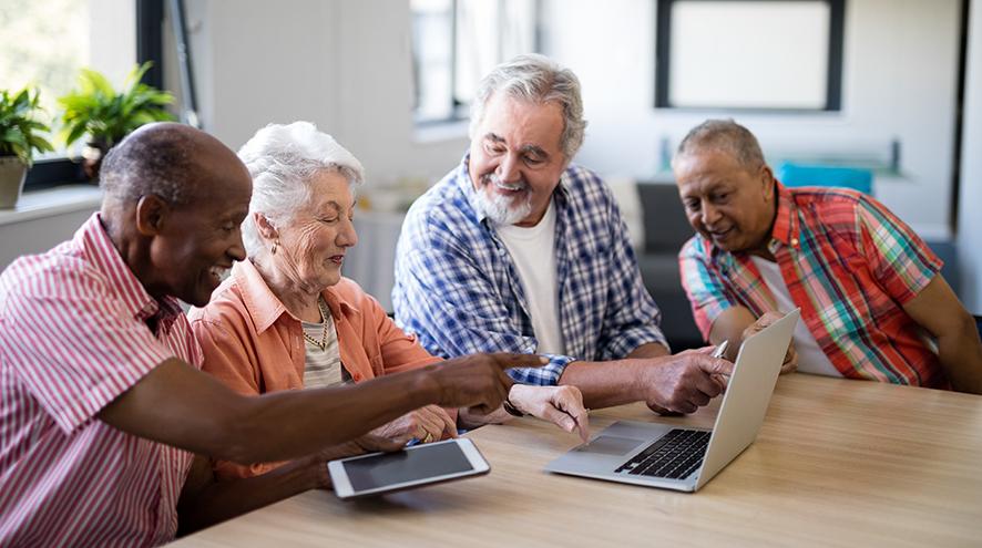 Group of seniors using a laptop together.