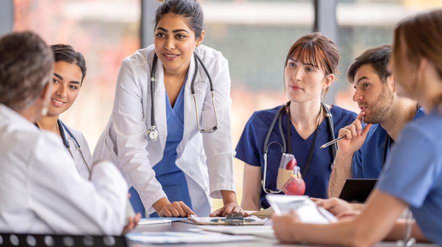 Six health-care workers around a table