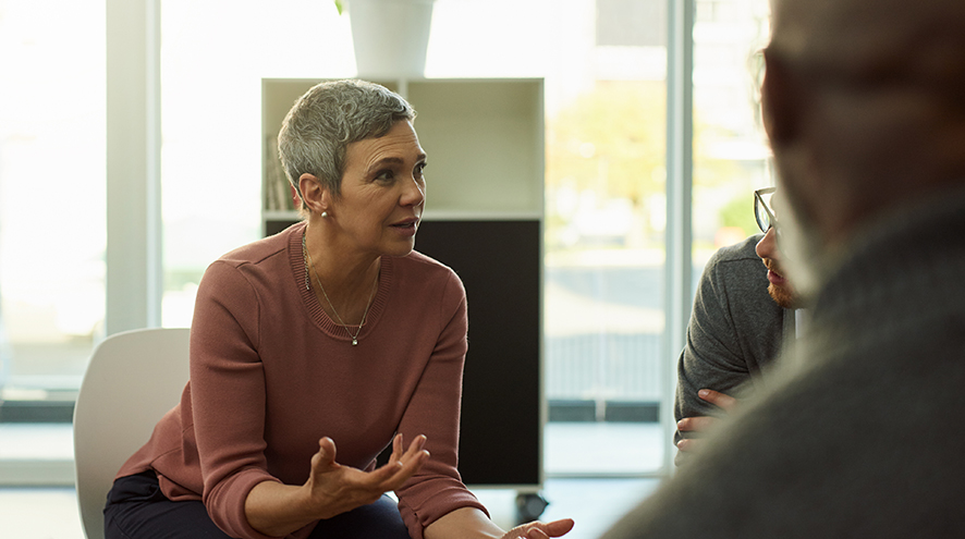 Middle-aged woman talking at support group.