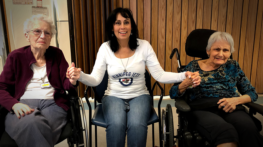 Linda van den Broek sitting with her mother and mother-in-law, both of whom are living with dementia.