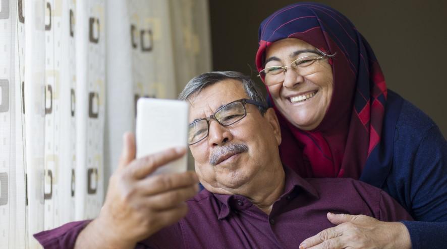 Senior couple looking at phone together.