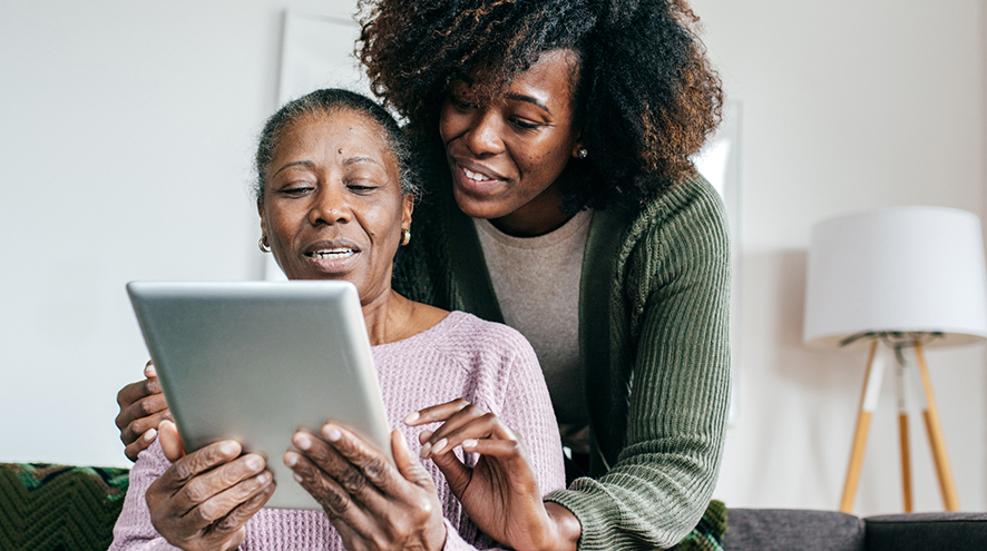 Mother and daughter using a tablet together.