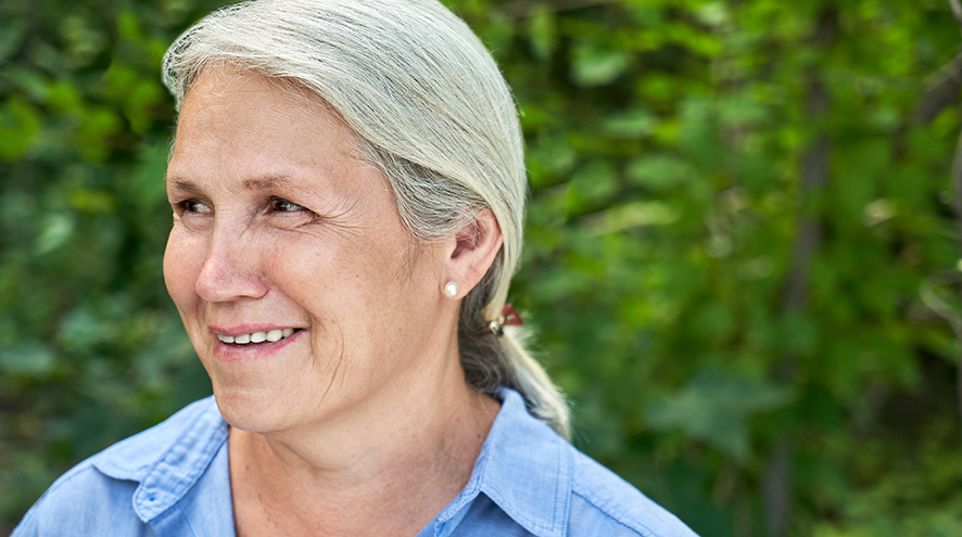 Smiling senior woman looking to the left.