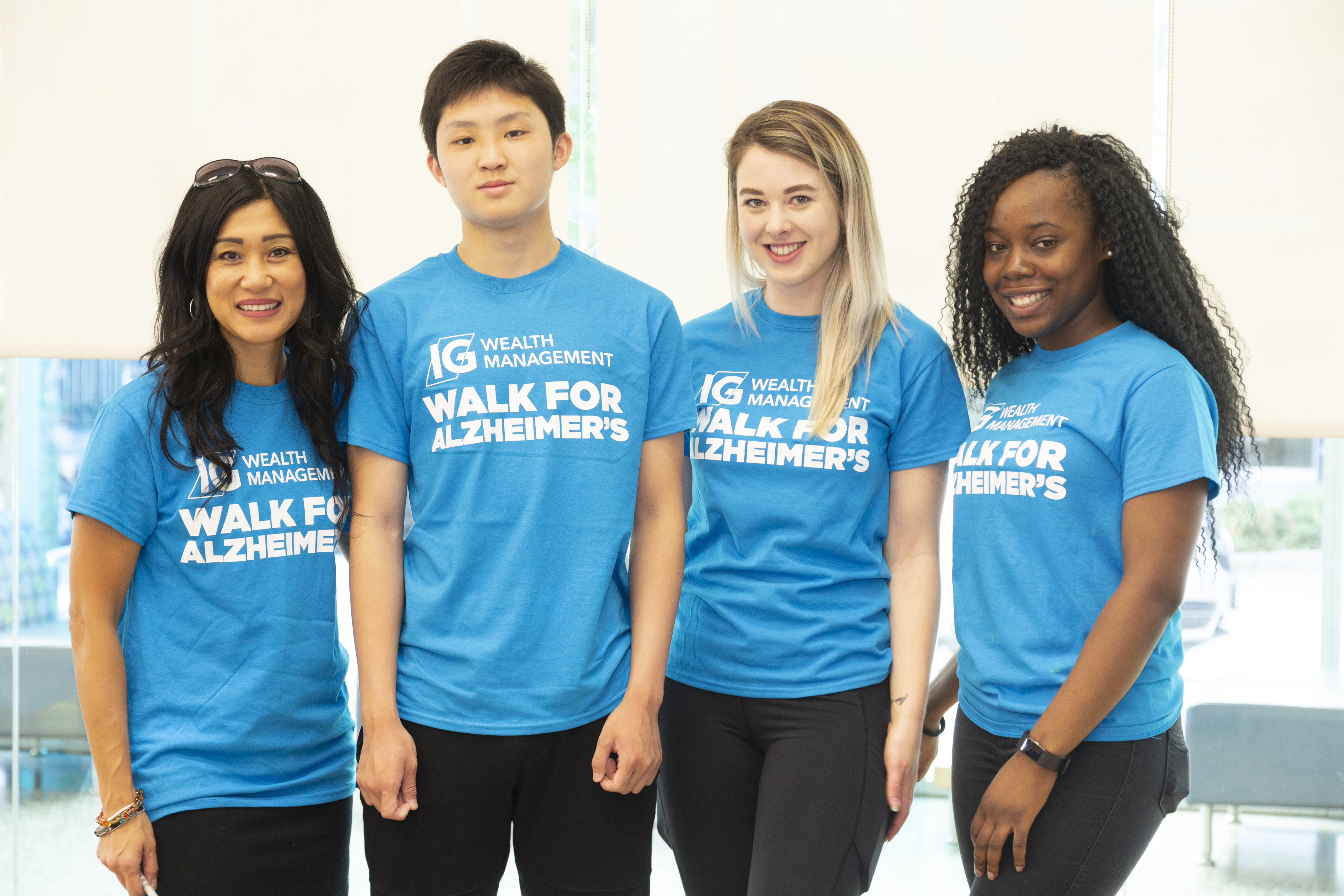 Group of young people smiling- Light Blue IG Shirt