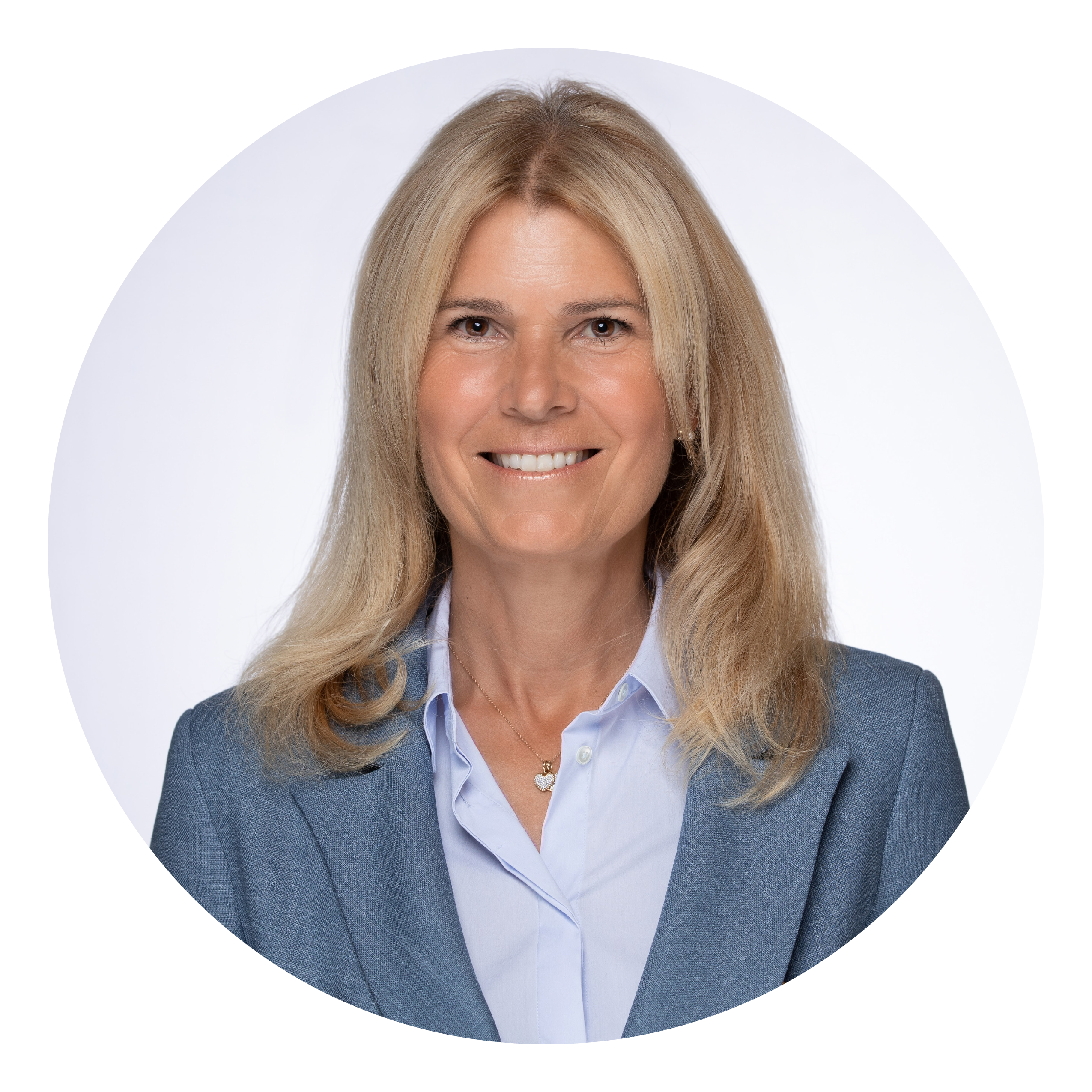 A midlife woman with shoulder length blonde hair in a blue blazer